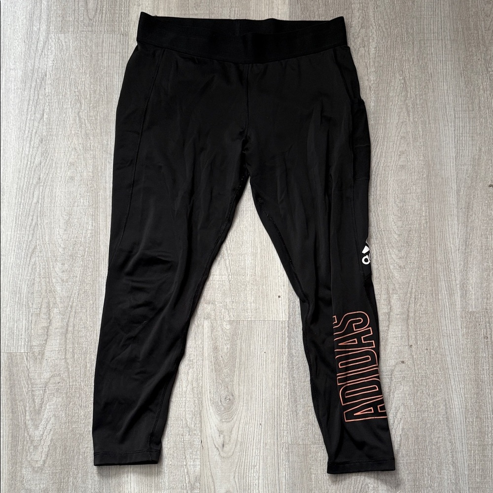 Adidas Black Leggings with Orange and White Logos.